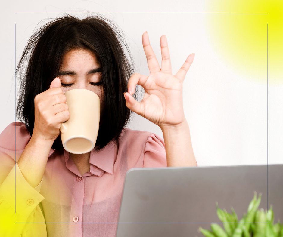 A tired looking woman drinking a caffeinaited drink in a cup